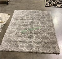Gray/white fluffy accent rug with foam backing
