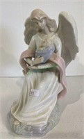 Porcelain angel with child figure measuring 8