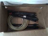 Box of power washer wands and a hose