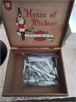 Wooden cigar box full of nail clippers
