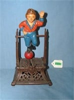 Boy on trapeze cast iron mechanical bank