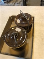 Two ceramic crocks in brown with snap handles