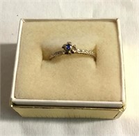 Ladies 14k gold ring w/ a blue stone.