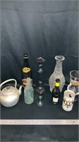 Metal teapot,  various bottles, metal candle