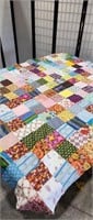 Vintage patchwork quilt top displayed on 5ft by