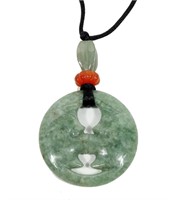 Jade pendant on black silk cord with jade accents