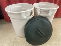 Pair of Rubbermaid garbage cans with lids. One