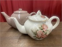 Two ceramic teapots. One is Country Rose.