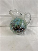 Water pitcher full of marbles, and it is heavy