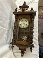 Very ornate, antique wall clock with key and