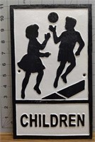 Cast iron children at play sign