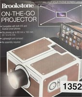 BROOKSTONE ON THE GO PROJECTOR RETAIL $30