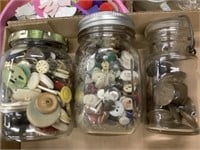 Three jars of miscellaneous buttons and snaps
