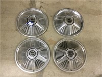 Four Mustang hubcaps