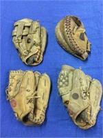 Four baseball gloves