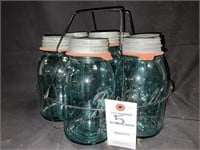7 VTG QUART BLUE BALL JARS IN A WIRE CARRIER