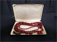 Pair of red beaded necklaces and clips