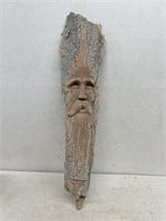 Carving of face in wood