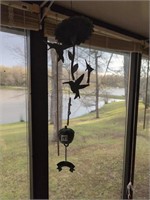 Metal hummingbird and apple windchimes