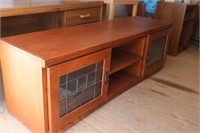 Newer TV stand on wheels with baskets