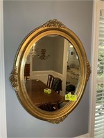 OVAL GOLD COLORED MIRROR APPROX 35 IN X 36 IN