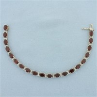 Oval cut Garnet and Diamond Tennis Bracelet in 14k