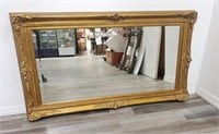 Ornate carved gilt wood wall mirror