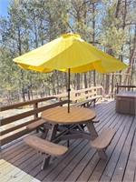Round picnic table with yellow umbrella