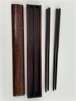 Pair of chopsticks in a wood storage case