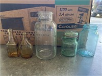 Clear glass jars, small bottles, & blue glass jars