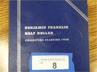 Folder with 26 Benjamin Franklin half dollars