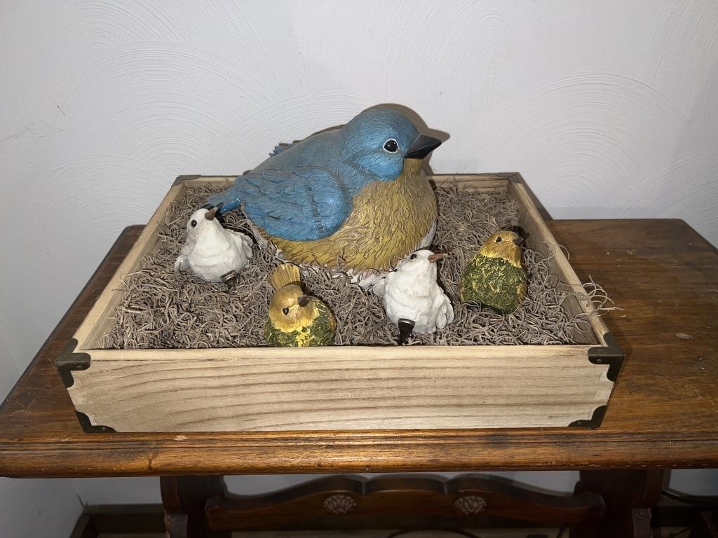Box of fake bird figurines