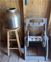 Aluminum milk jug, wooden stool, & hose spool