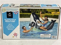 Members mark inflatable orca float