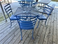 Wrought iron   table with 4 padded chairs
