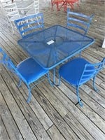 Wrought iron table with 4 padded chairs