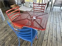 Wrought iron table with 3 padded chairs