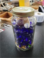 Jar with marbles gemstones and buttons