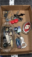 lot of bottle openers and a belt buckle