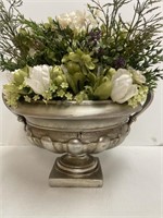 Polyresin plant holder with group of flowers.