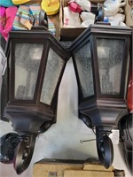 Two outdoor wall sconce lights one glass broken