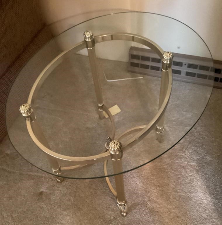 Oval glass top end table with brass base