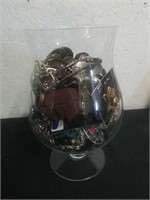 8 in glass full of jewelry, buckles, coins, and