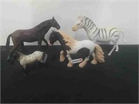 Toy horses and a zebra