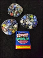 Three bags of marbles with small little booklet