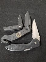 Three pocket knives one is Timber Wolf leader of