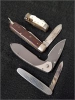 Four pocket knives one says Germany one is a buck