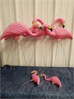 Group of plastic flamingo yard decor