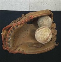 Vintage baseball mitt with baseballs