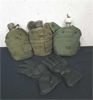 Three military canteens and a pair of gloves
